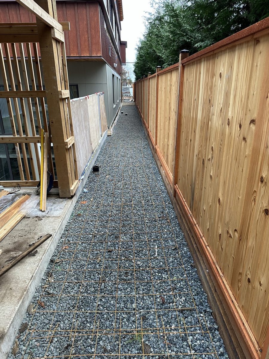 New cedar fence beside a gravel side path