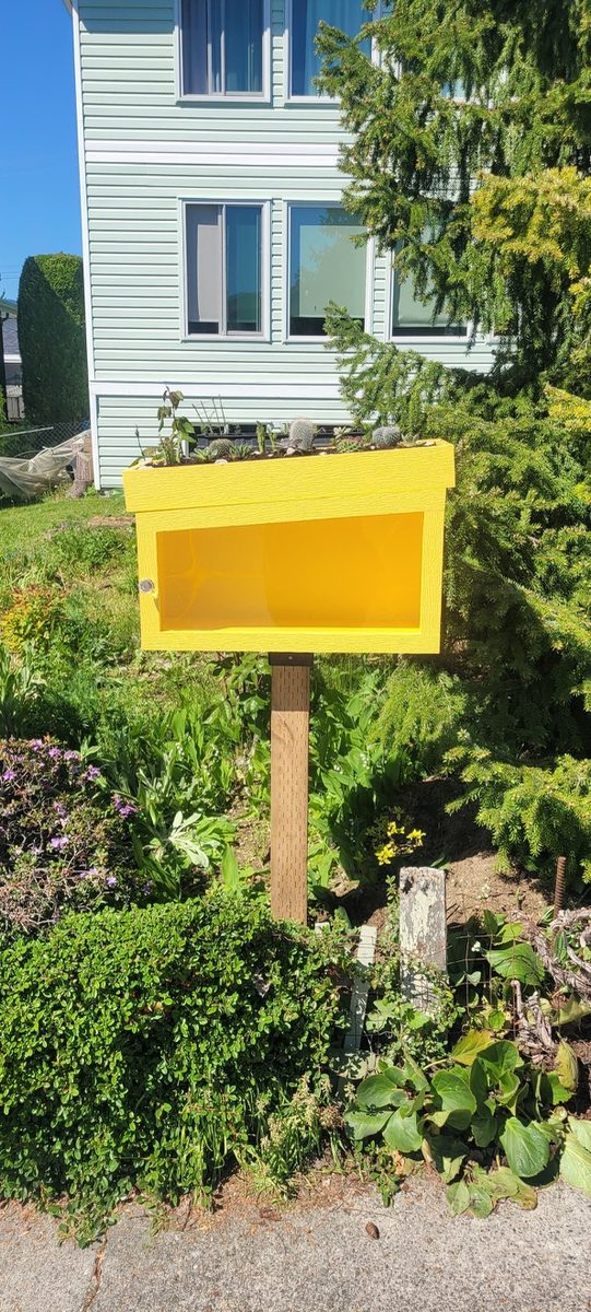 Finished yellow box mounted on a post in a front garden