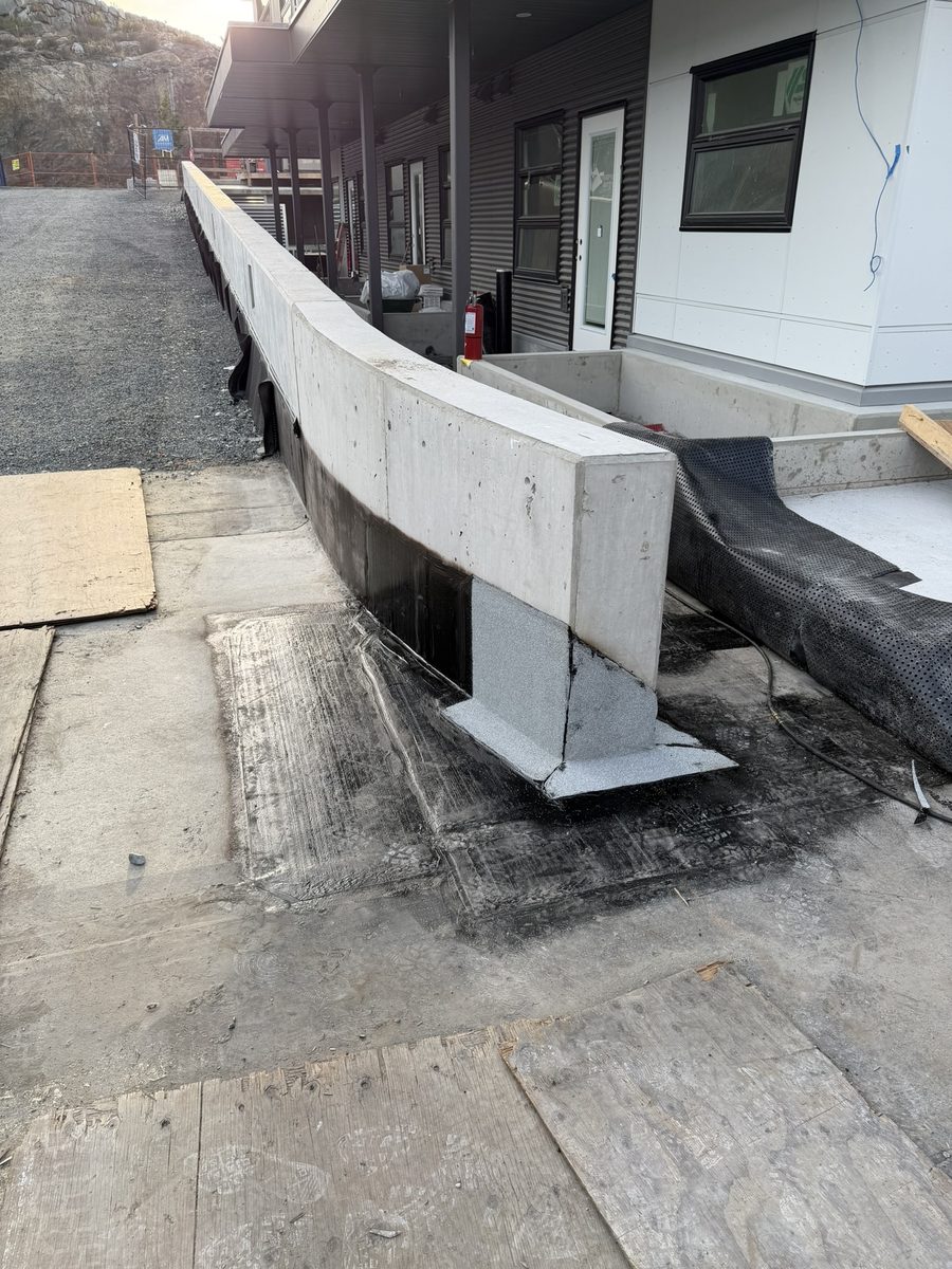 Torch-on membrane flashing at the corner of a concrete wall