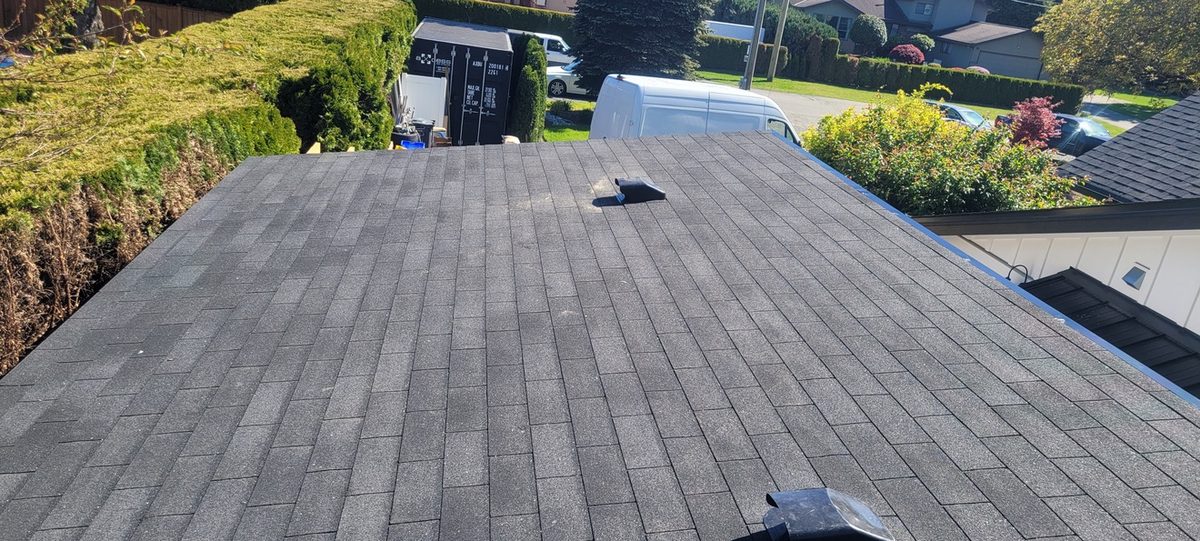 Finished asphalt shingle roof with new roof vent