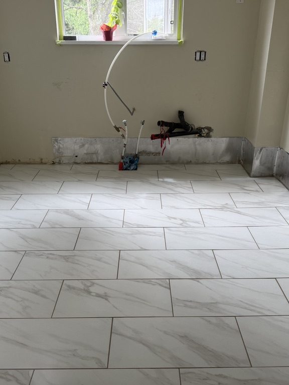Finished large-format marble-look tile floor