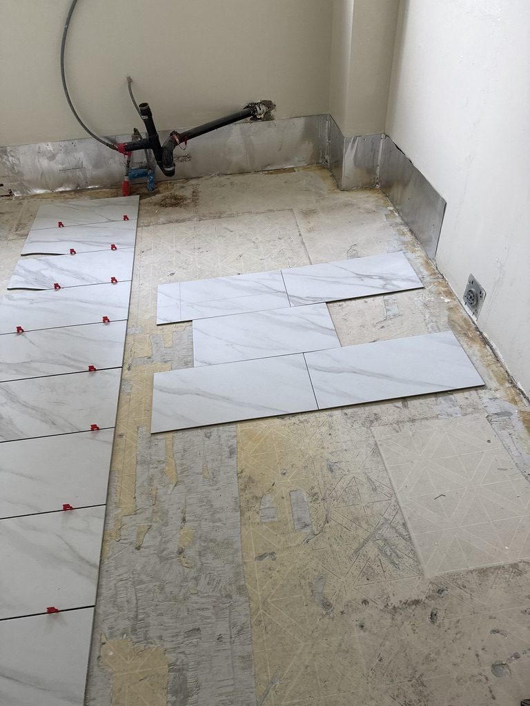 Tile being laid out on a stripped subfloor