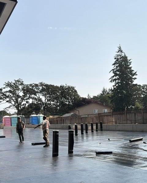 Crew torching down the base sheet on a large covered deck