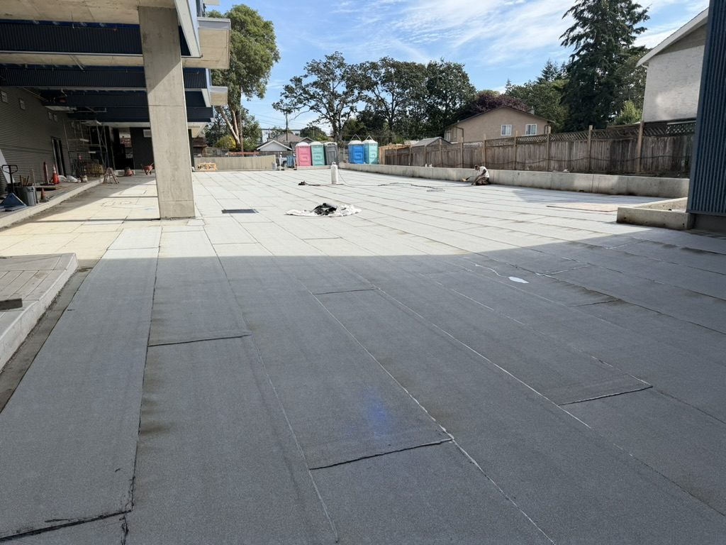 Granulated cap sheet being torched over the base sheet